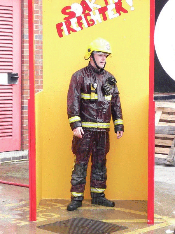 A Fire-fighter getting wet.