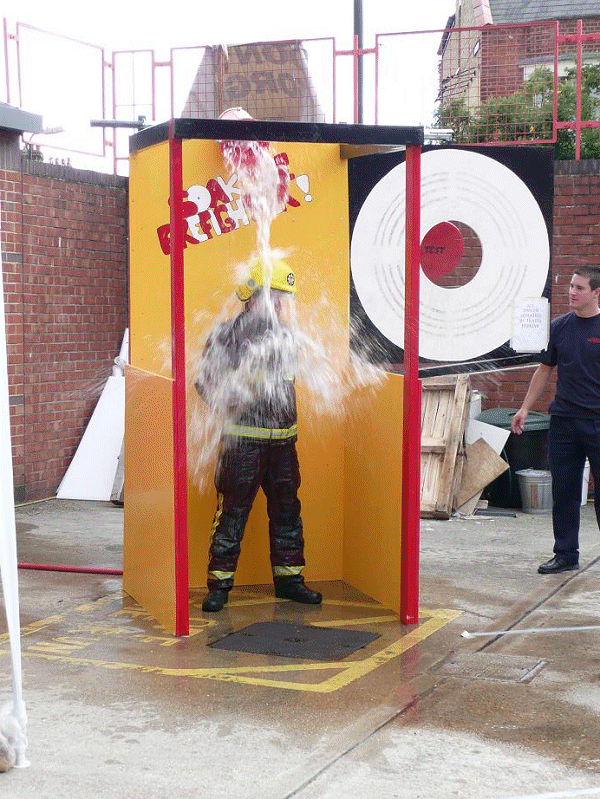 A Fire-fighter getting wet.